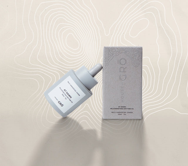 House of GRŌ At Dawn Rejuvenating Daytime Oil glass bottle and its textured retail packaging box on a light background.